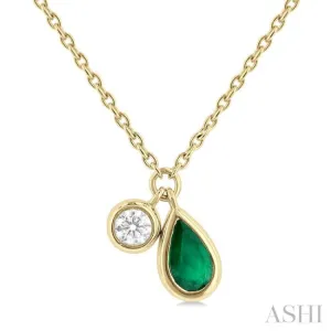 1/50 ctw Pear Cut 6X4MM Emerald and Bezel Set Round Cut Diamond Precious Necklace in 10K Yellow Gold